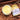 four jars of naturally soapy body butter on top of a cream fur blanket surrounded with avocados, coconut and shea butter. 