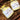 Two jars of Naturally Soapy handmade body butter on a wooden surface with straw.
