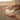 Person holding a bar of hair Conditioner under running water