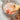 Jar of peppermint bath salts containing epsom salt and pink Himalayan salt with a wooden spoon on a light background