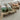 Handmade soaps on natural soap dishes and soap saver bags with string ties on a light surface.