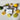 Three bars of black and cream coloured Naturally Soapy soap with white soap strip label around them and company logo printed on it. Soaps have lemons and limes scattered around them on top of a marble surface 