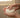 Person holding a bar of Rosemary and lemon hair conditioner under running water